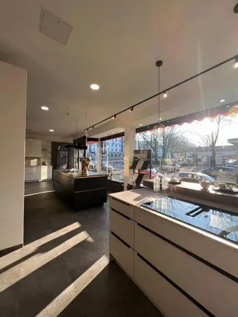 Moderne Küche mit großen Fenstern und Sonnenlicht, Blick auf die Straße.